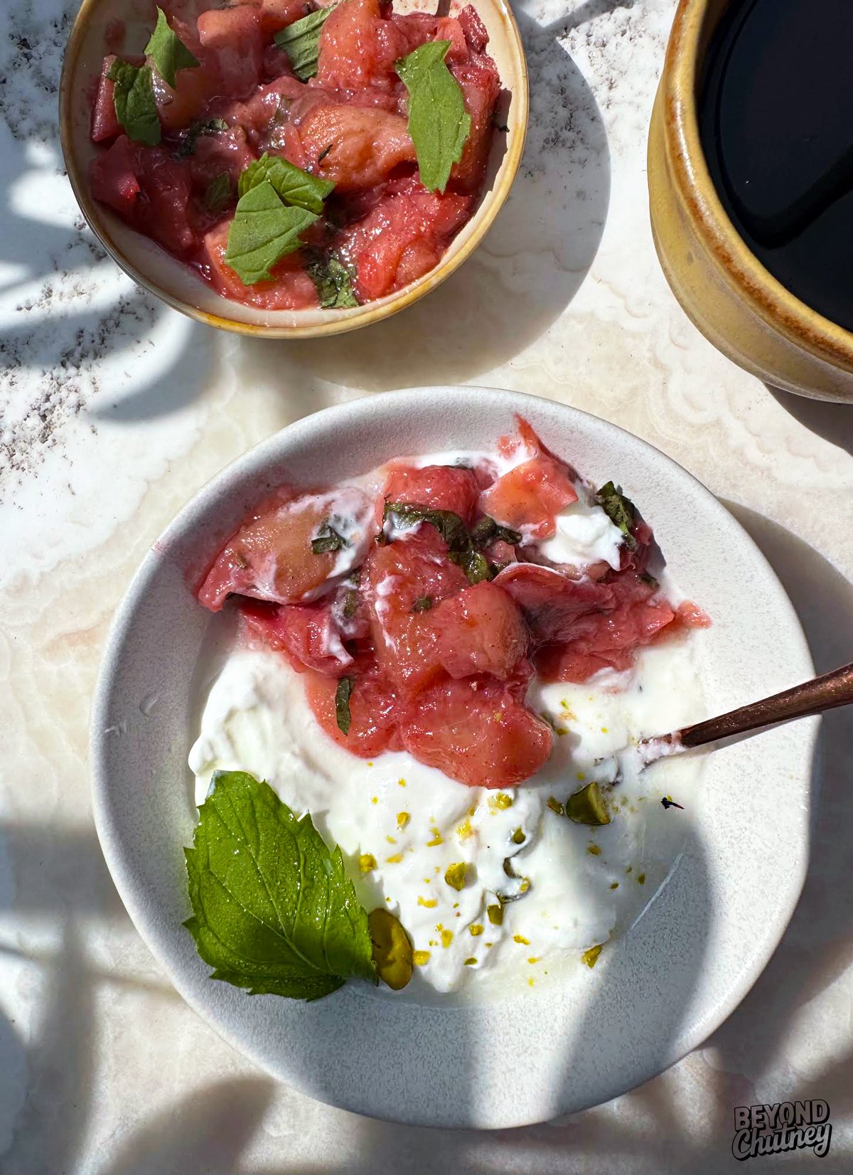 Peach compote with yogurt, a sprinkle of pistachio and a hint of lemon - simple, bright and just sweet enough.