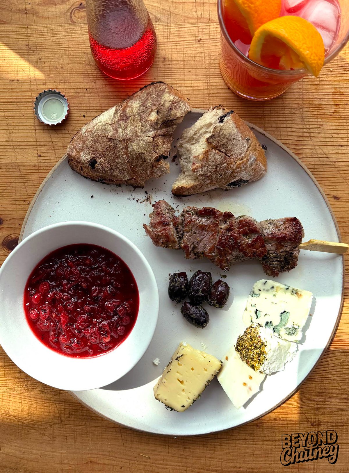 Red currant rosemary chutney doing its thing with grilled lamb, olives, a mix of cheeses—and a Campari O off to the side. Tart, herby, salty, bitter... somehow it all plays nice together.