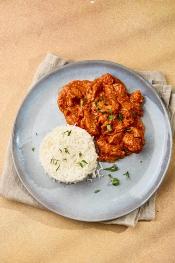 Butter Chicken (Murgh Makhani) served in a plate with rice