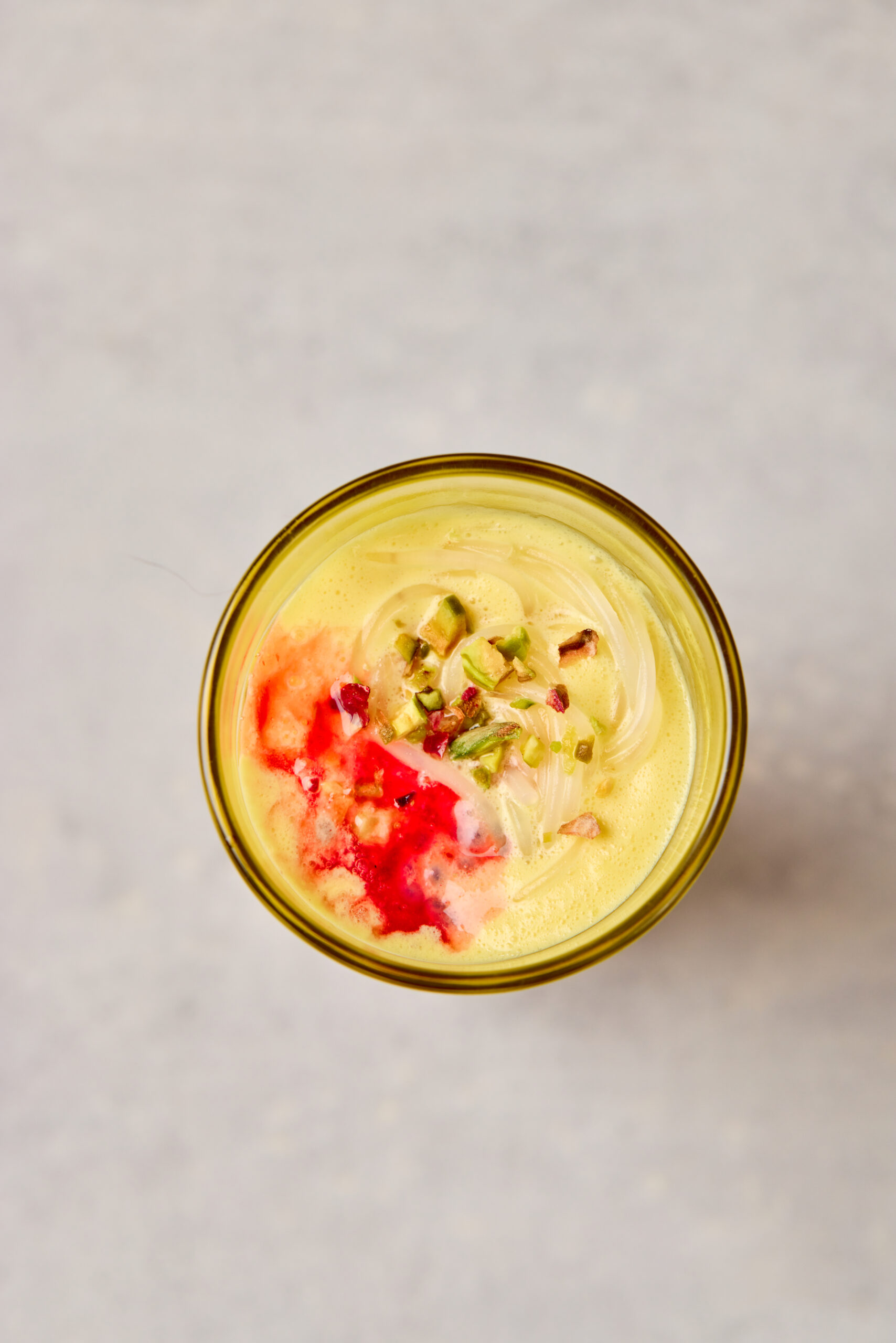 Close-up of Falooda showing layers of rose milk, vermicelli, and ice cream