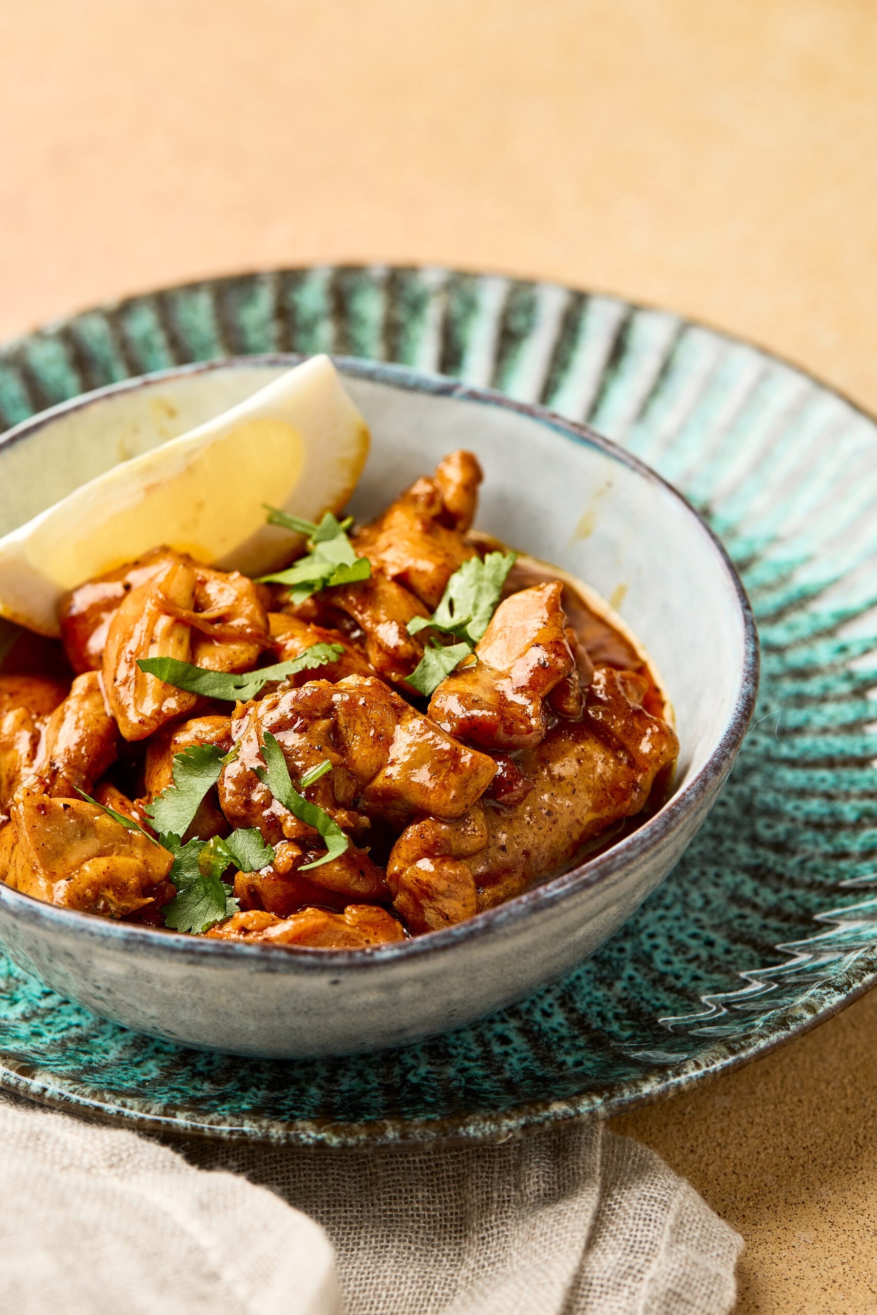 Close-up of garlic butter chicken showing juicy chicken pieces coated in creamy garlic butter sauce with cumin and herbs