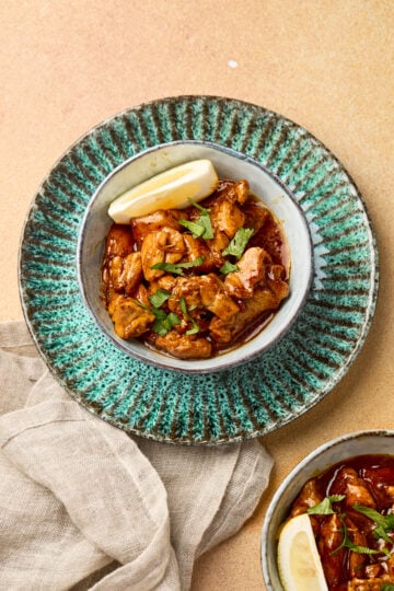 Garlic butter chicken served in a bowl with golden seared chicken pieces coated in rich garlic butter sauce, garnished with herbs
