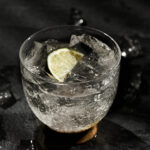 Glass of lime soda with ice cubes, fresh lime slices, served as a cooling Indian summer drink