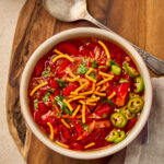 Manchow Soup served in a bowl, topped with crispy fried noodles and garnished with spring onions.