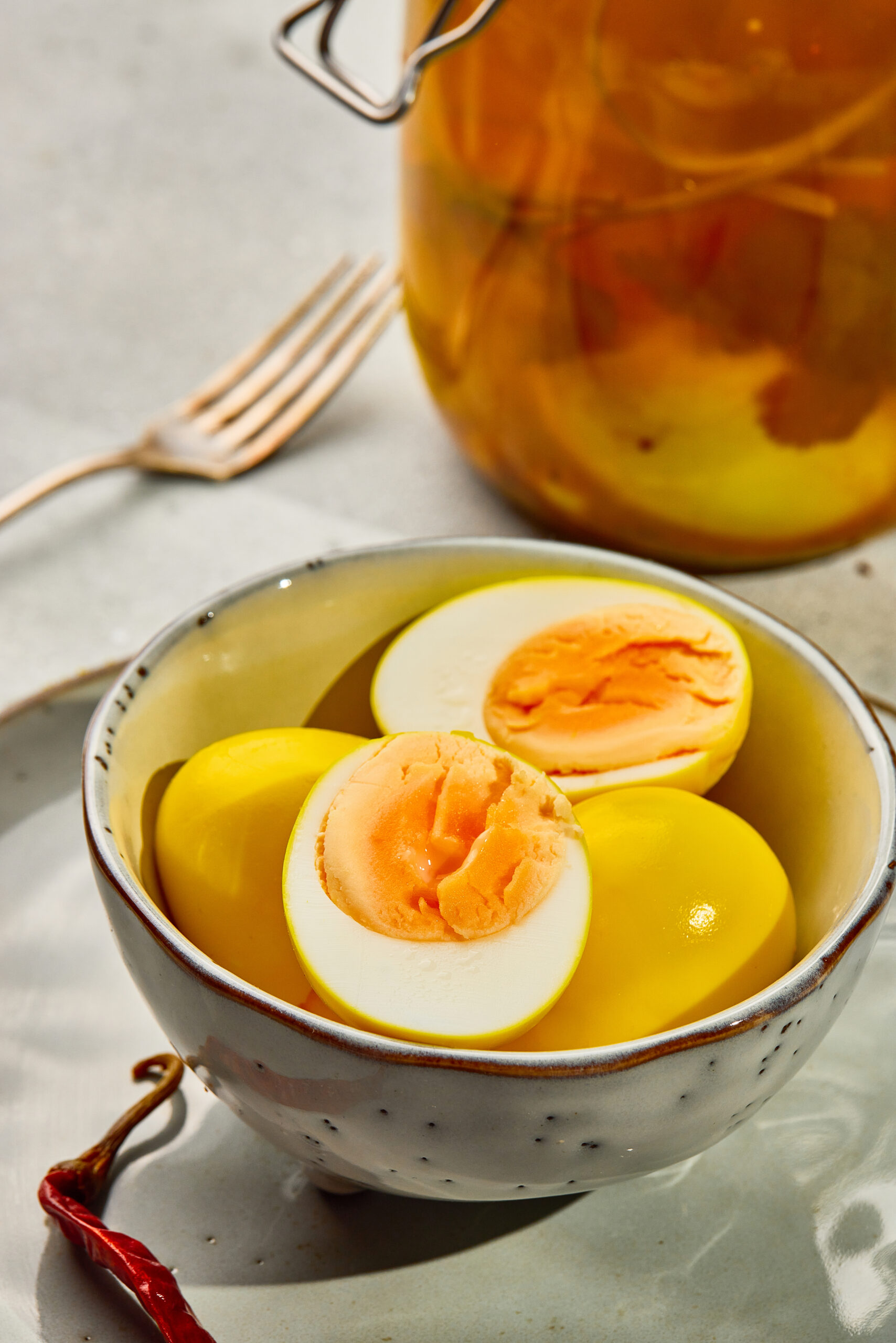 Close-up of pickled eggs with vibrant pink edges from beet-infused vinegar brine