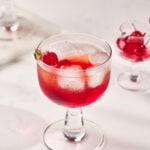 Classic Shirley Temple Drink served in a tall glass with ice, grenadine, and maraschino cherry garnish.