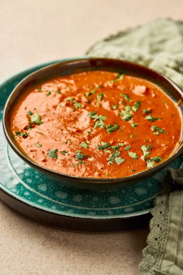 Tikka Masala Sauce in a bowl with creamy tomato base, garnished with cilantro.