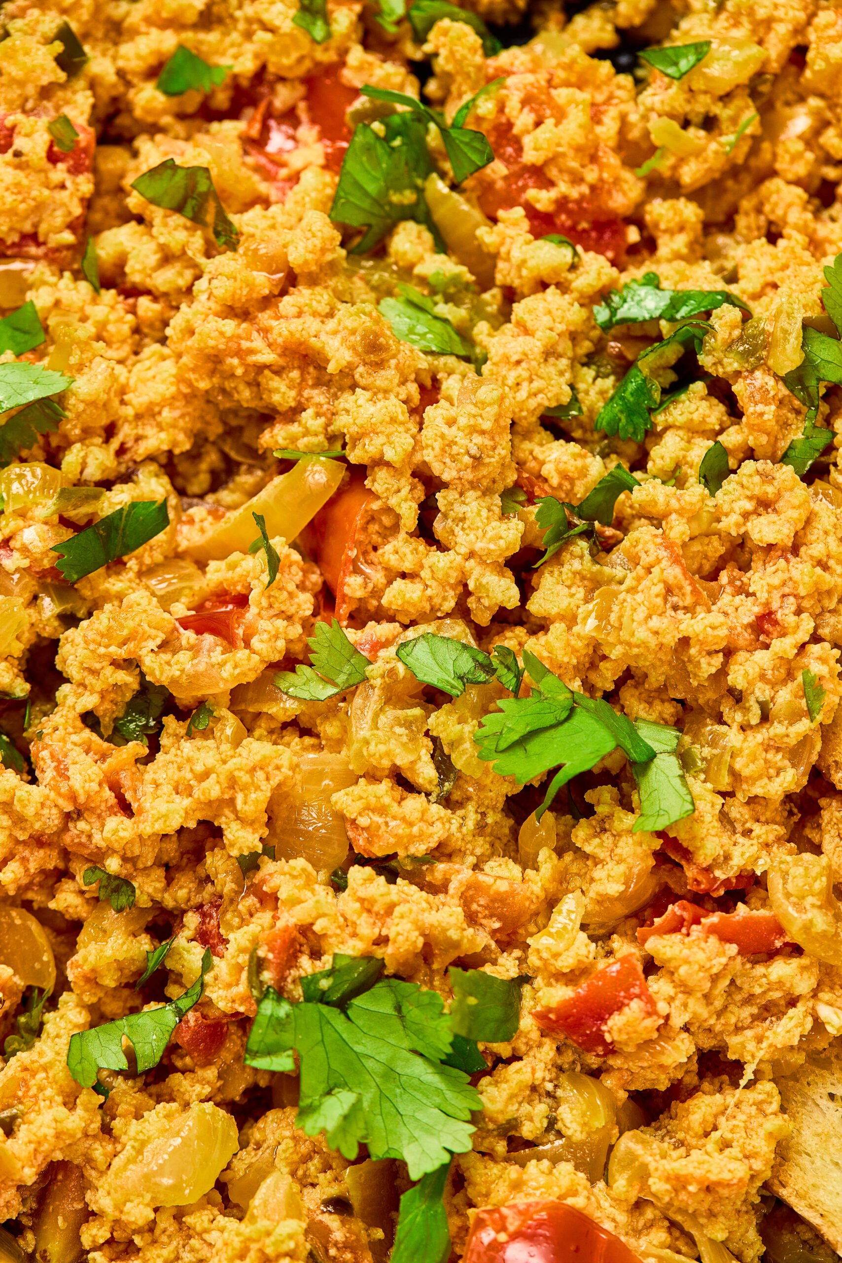 Close-up of Egg Bhurji showing fluffy scrambled eggs mixed with onions, tomatoes, and spices.