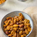 Spiced Nuts served in a bowl, coated with chili, cumin, and honey glaze for a sweet and savory flavor.