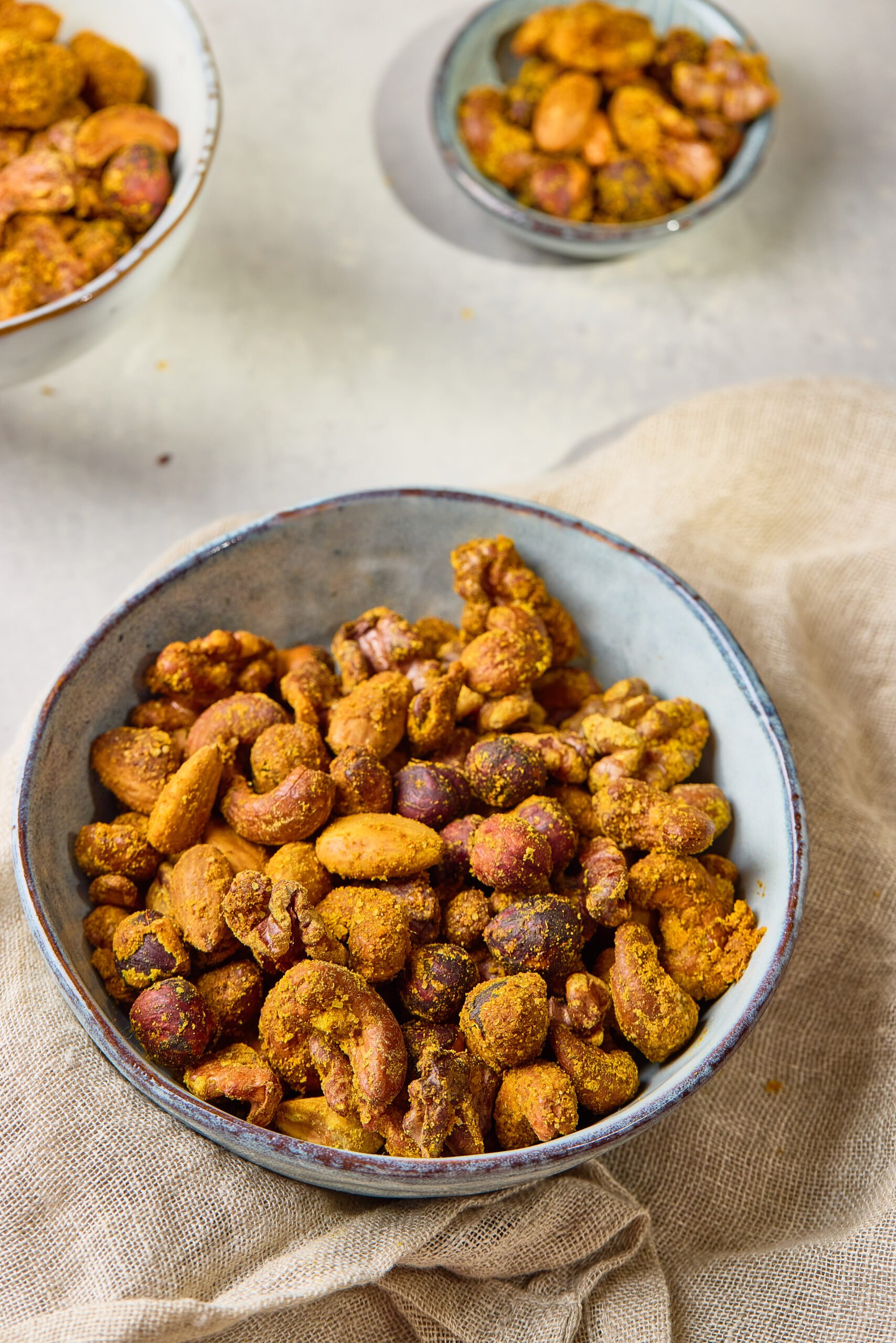 Spiced Nuts served in a bowl, coated with chili, cumin, and honey glaze for a sweet and savory flavor.