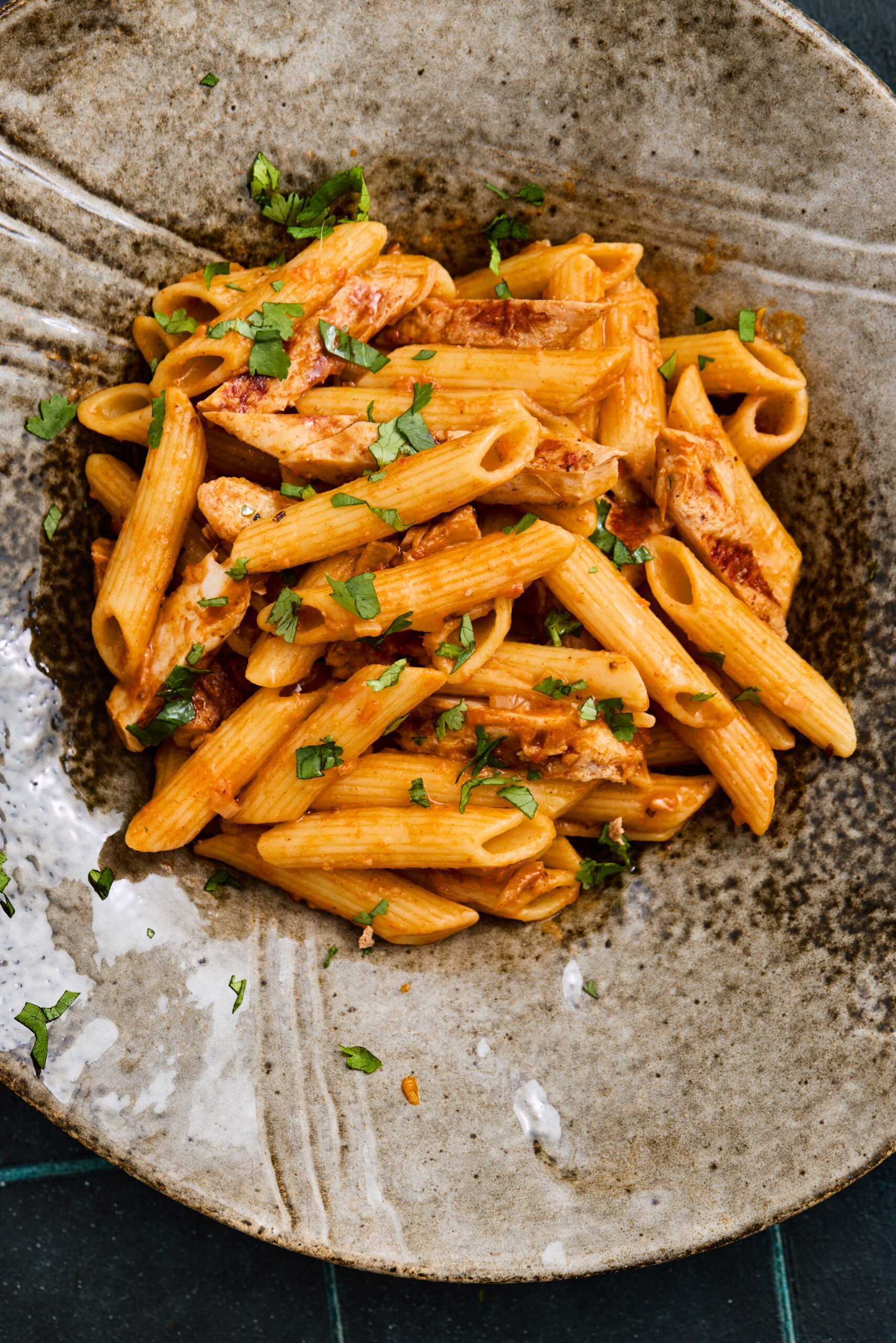 Butter chicken pasta with tender chicken and creamy tomato sauce.
