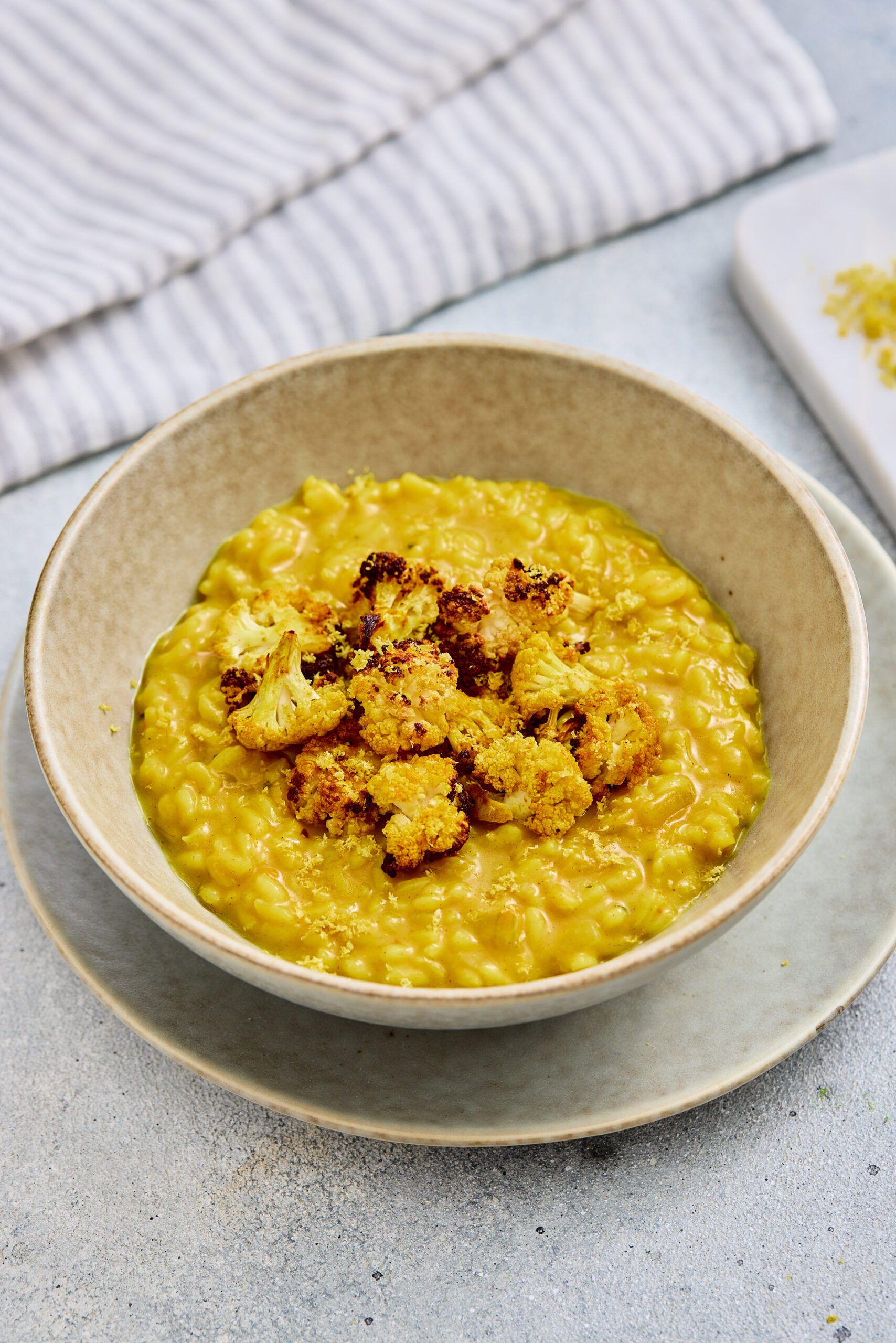 Curry risotto with roasted cauliflower in a bowl 