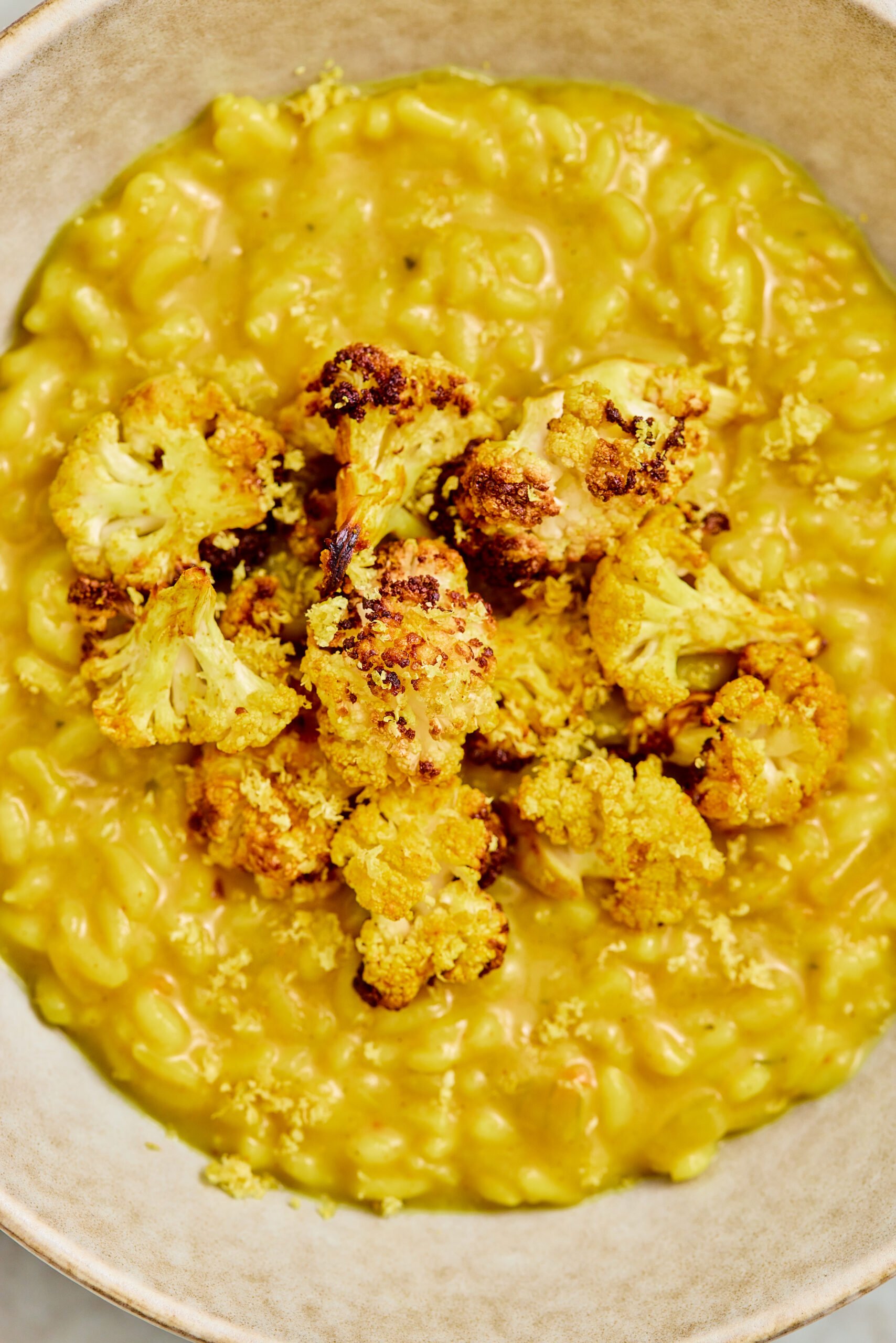 Close-up of creamy curry risotto with roasted cauliflower