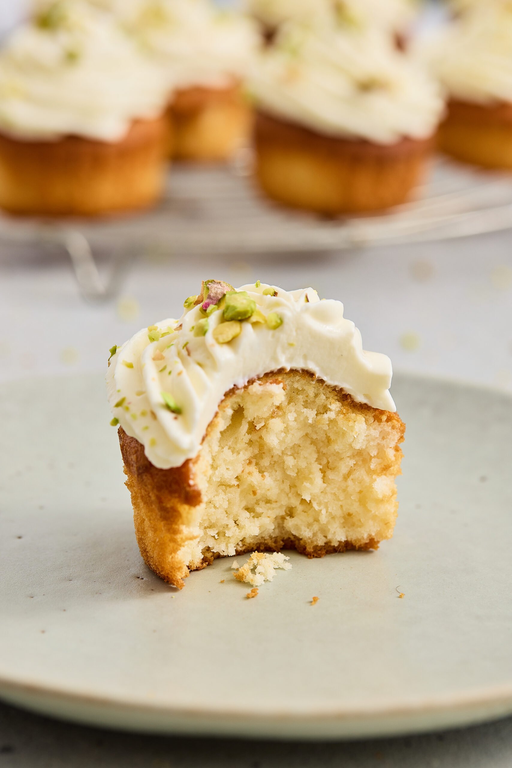 Bite taken from a gulab jamun cupcake with fluffy texture inside