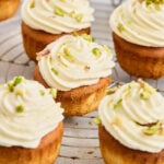 Gulab jamun cupcakes topped with cream frosting and pistachios