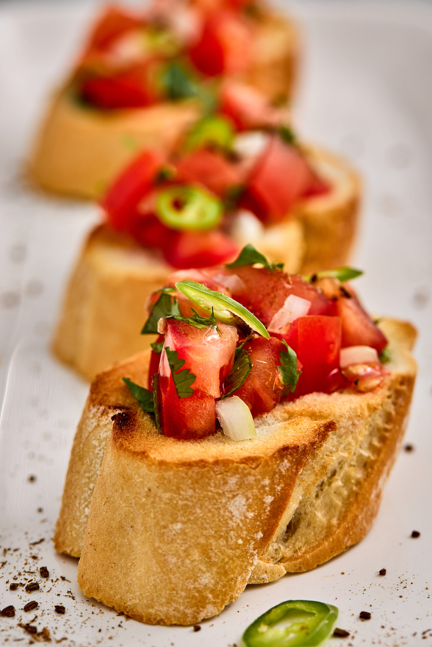 Close-up of Masala Bruschetta showing juicy spiced tomato topping.
