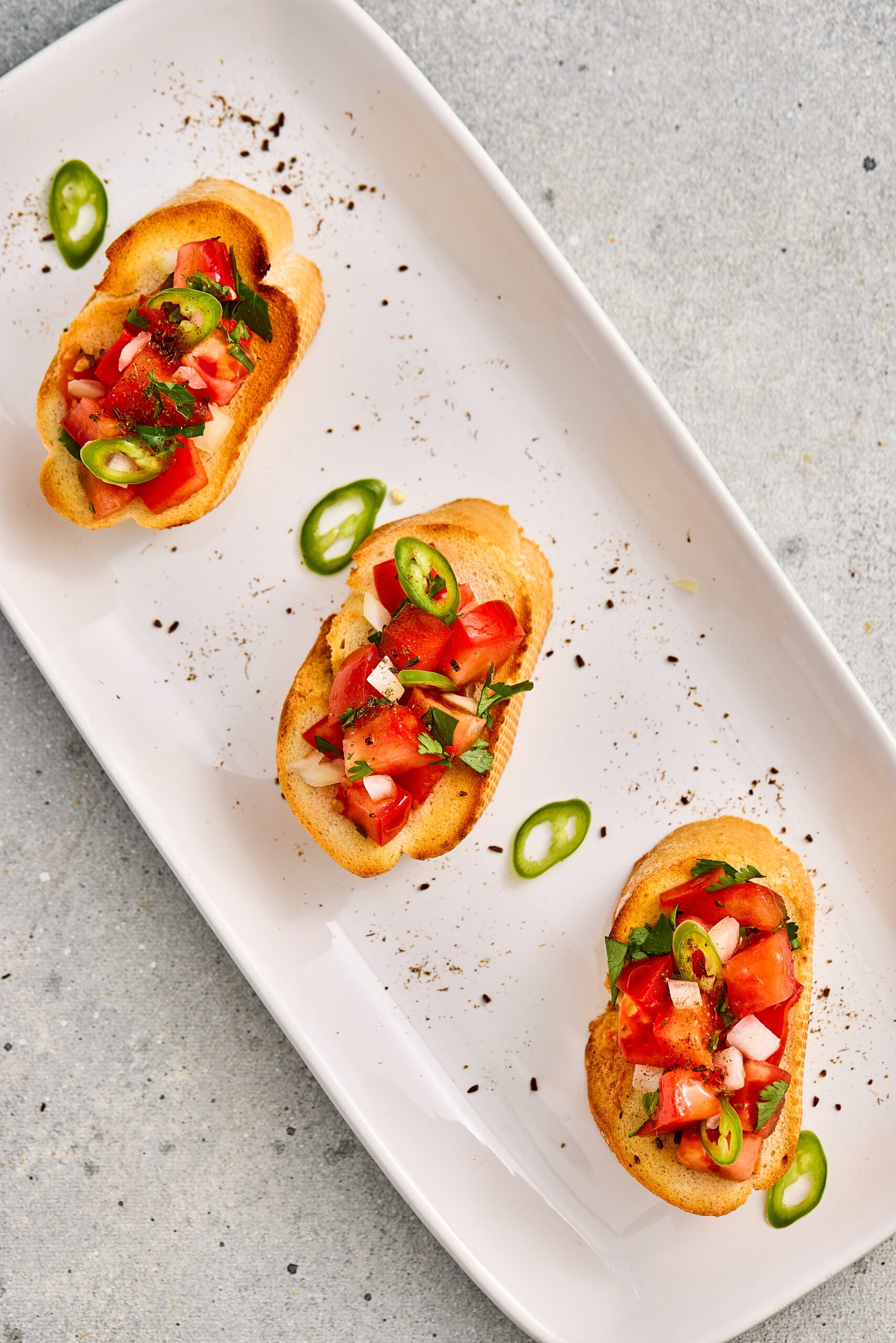 Masala Bruschetta topped with spiced tomatoes on crisp toasted bread.