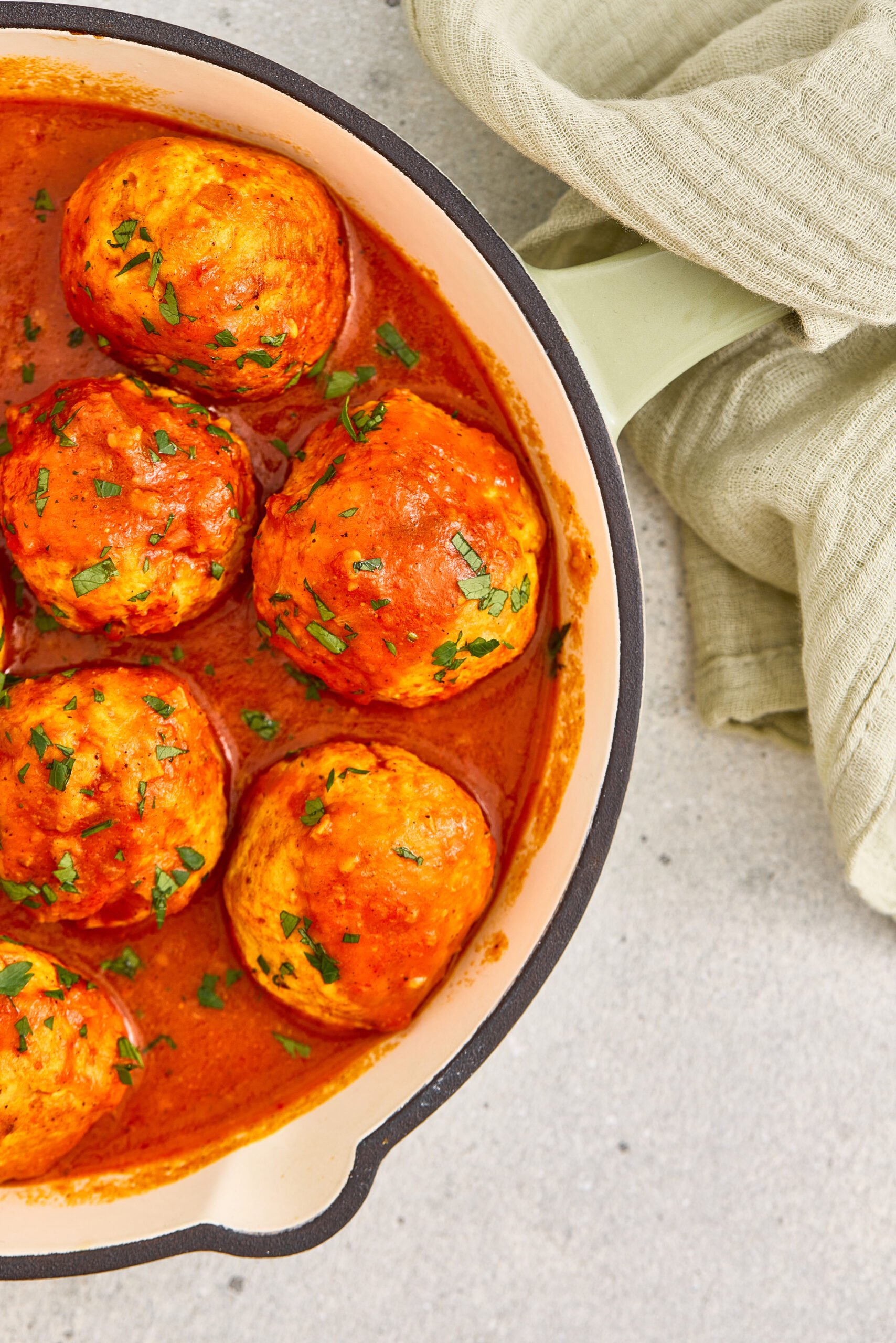 Close-up of masala meatballs in a flavorful tomato curry sauce.