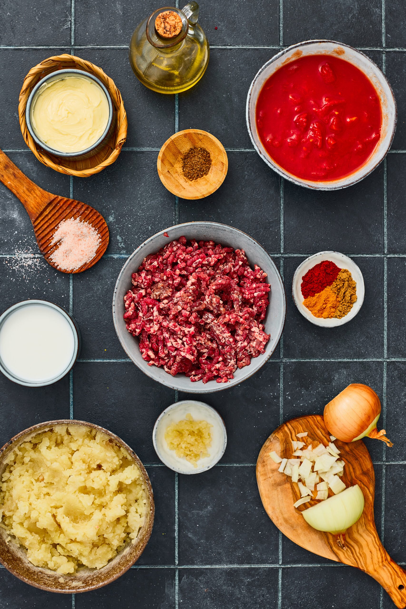 Ingredients for Masala Shepherd’s Pie including minced meat, potatoes, onions, and spices.