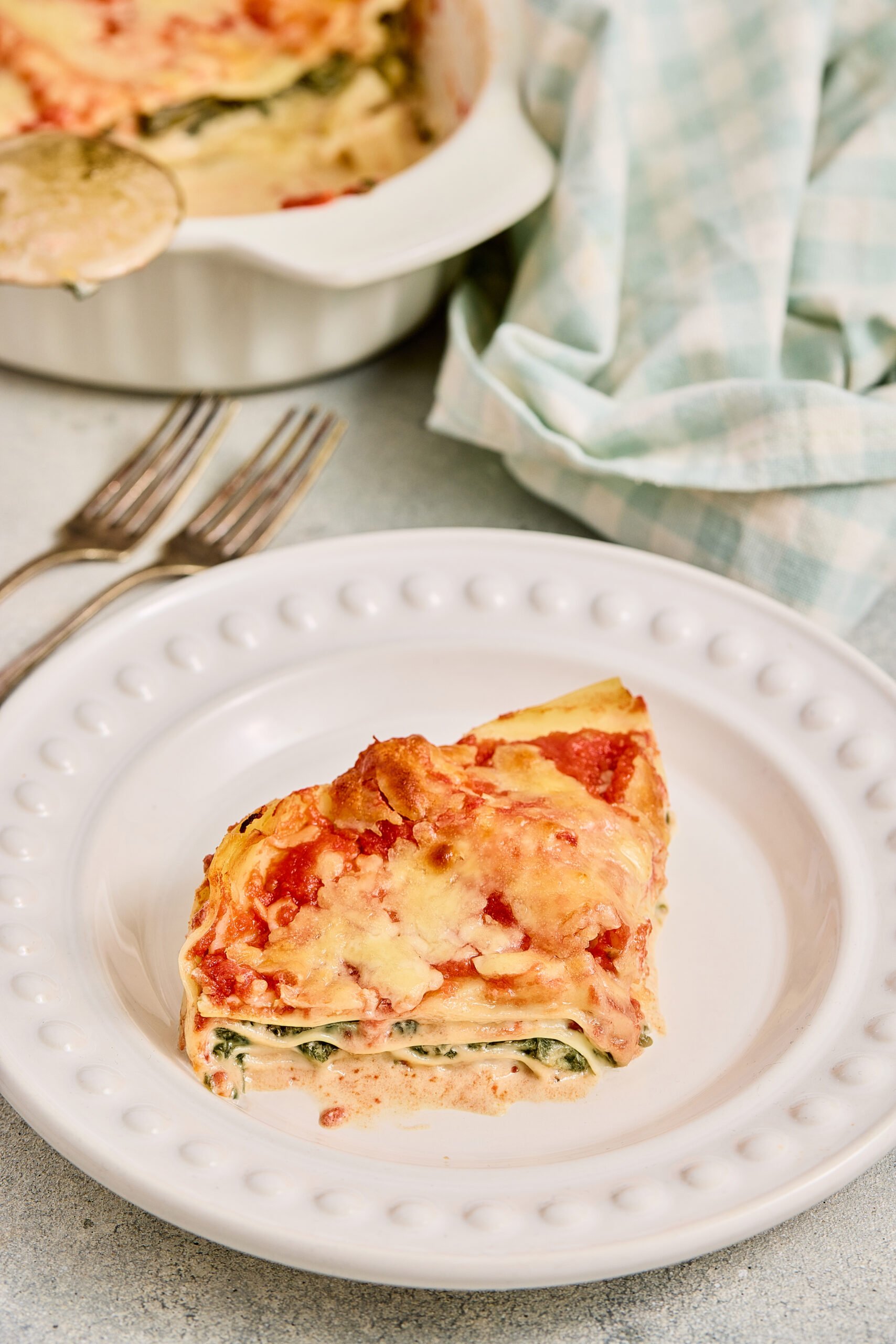 Palak paneer lasagna served warm on a dinner plate