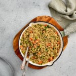 Quinoa Pulao served in a bowl with colorful vegetables and fresh coriander on top.