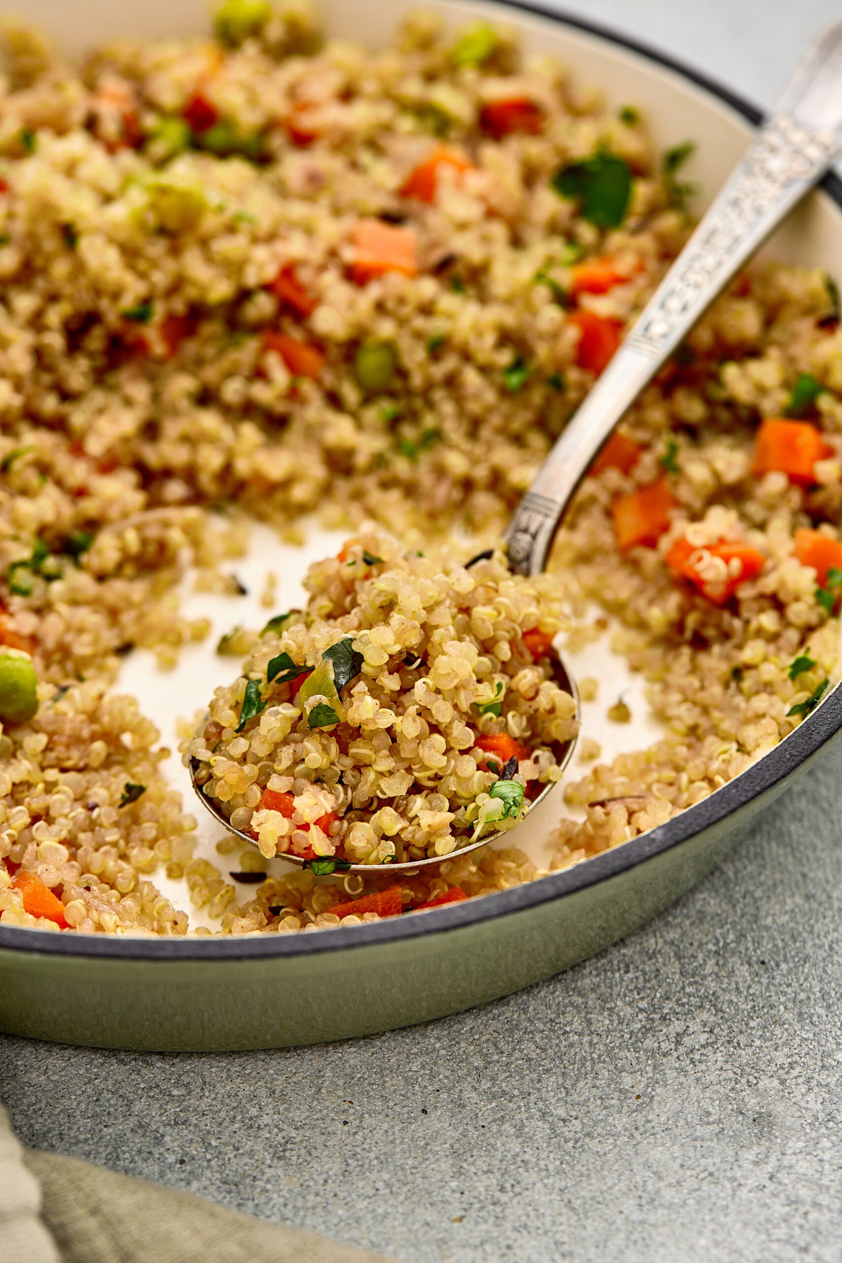 Close-up of fluffy Quinoa Pulao with peas, carrots, and warm Indian spices.