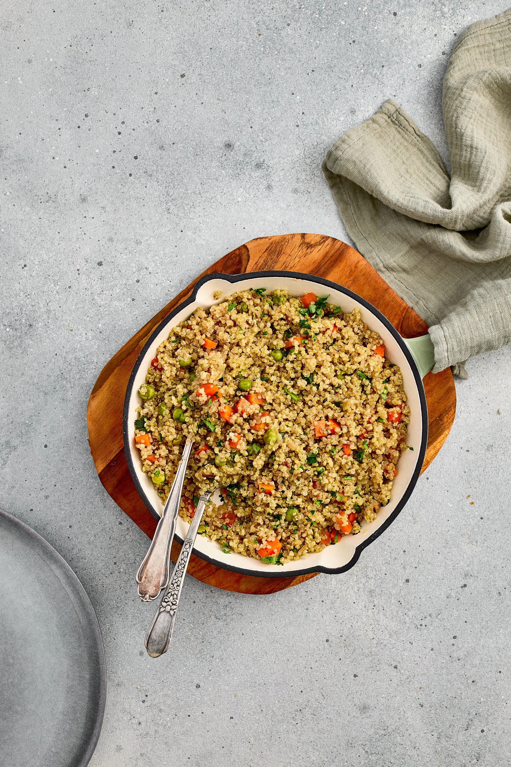 Quinoa Pulao served in a bowl with colorful vegetables and fresh coriander on top.