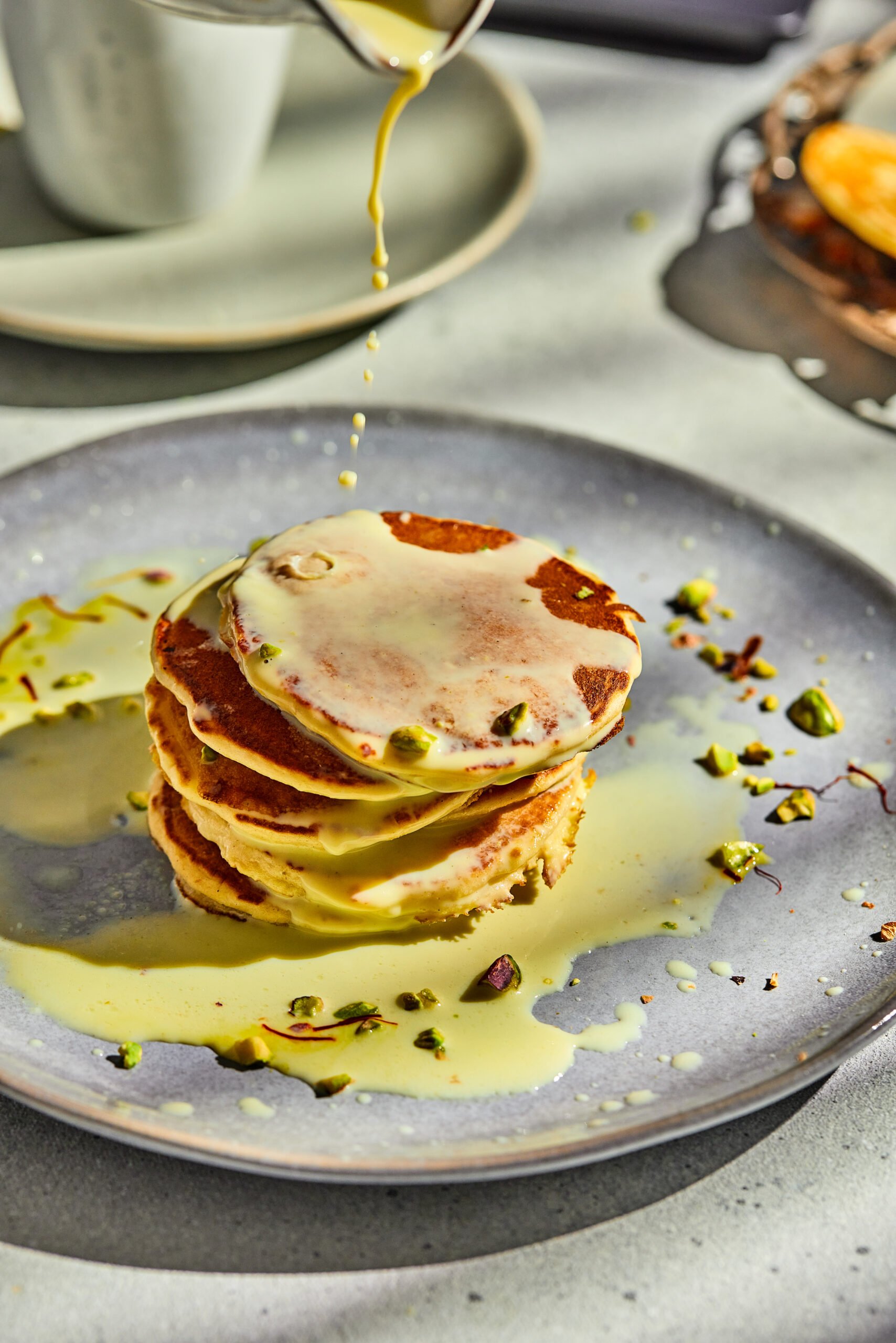 Rasmalai pancakes stacked with creamy topping