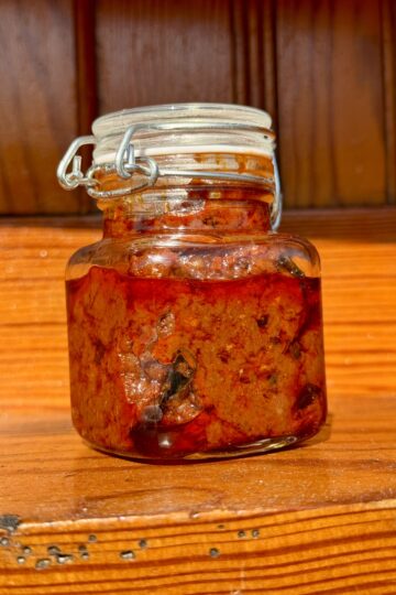 Homemade tomato pickle stored in a glass jar