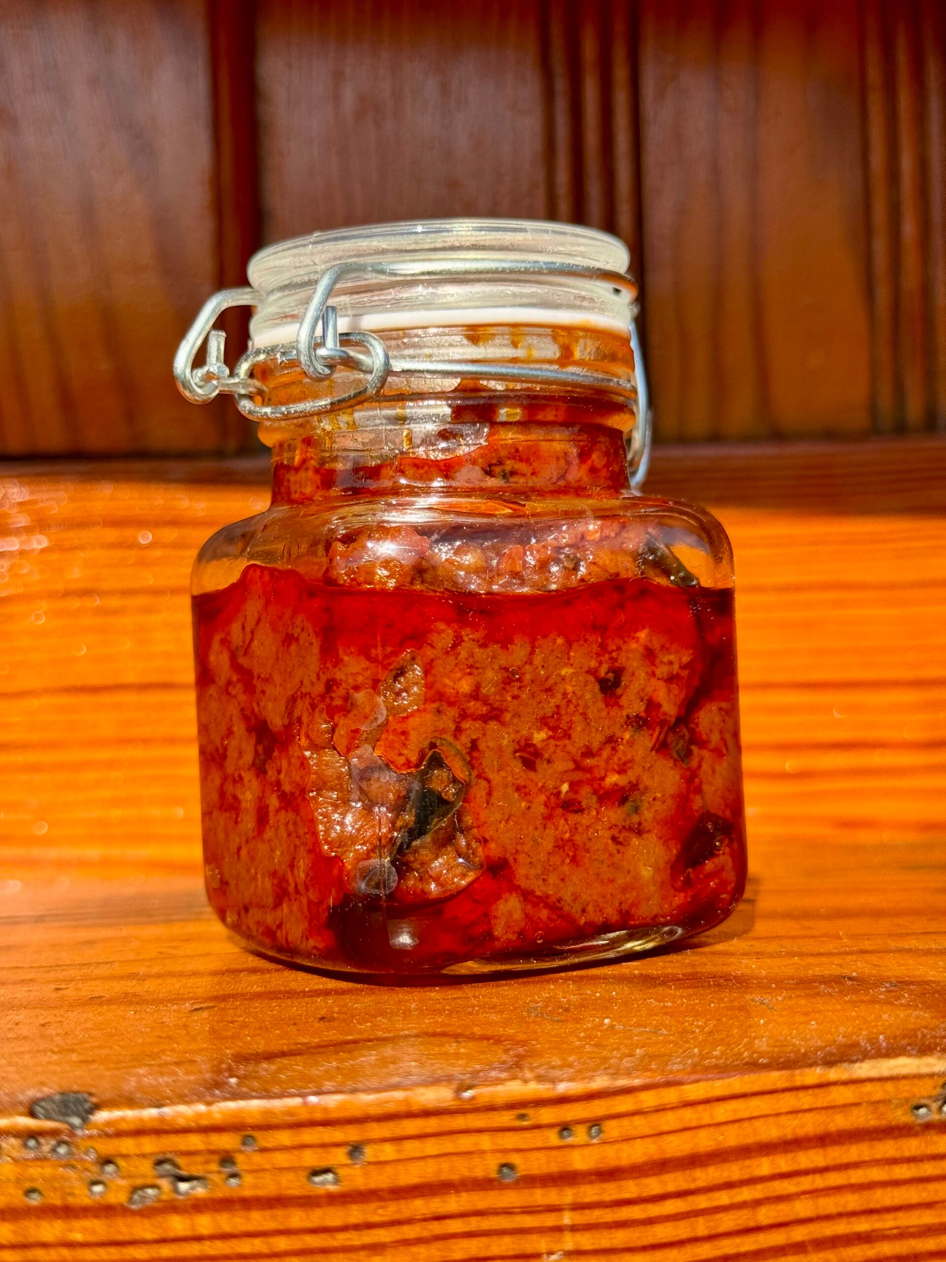 Homemade tomato pickle stored in a glass jar