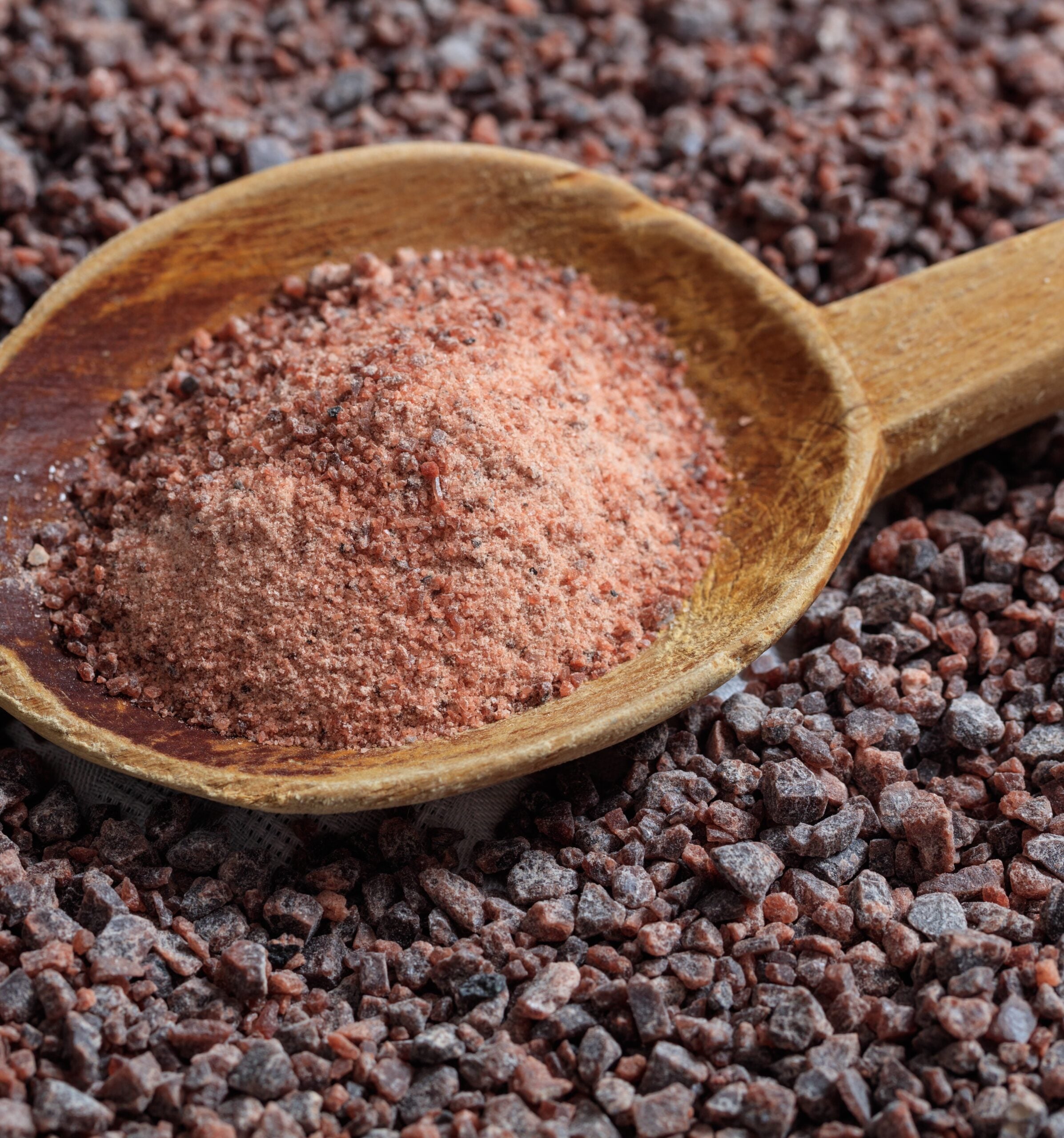 Kala namak (Black Salt) in a wooden spoon.