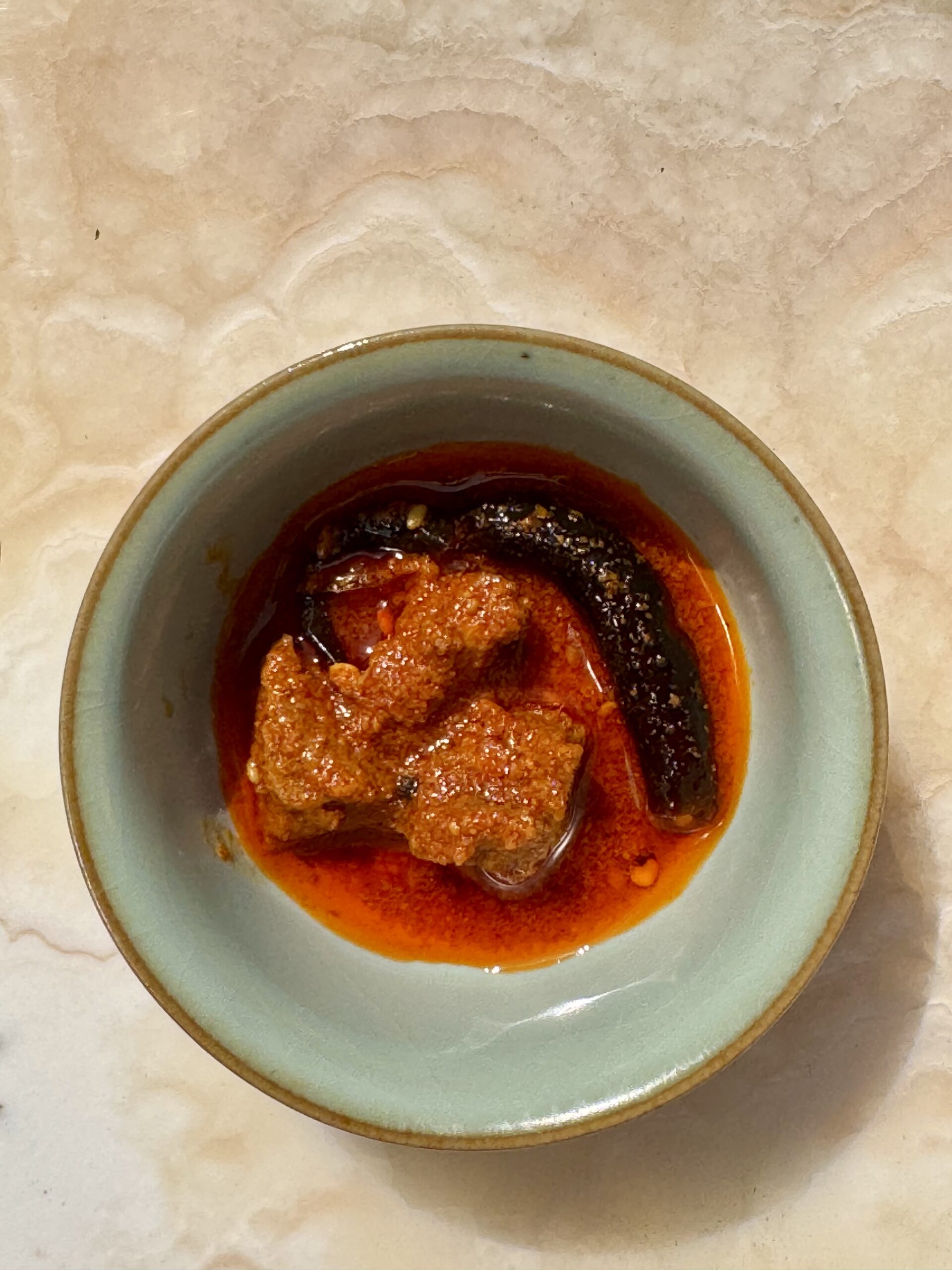 Red chili pickle ready to serve in a bowl.